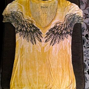 Mustard color. Sinful shirt! Beautiful wings on back of shirt.